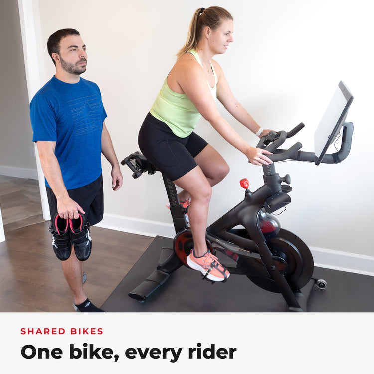 Couple sharing one Peloton bike, one in sneakers with Toe Cages