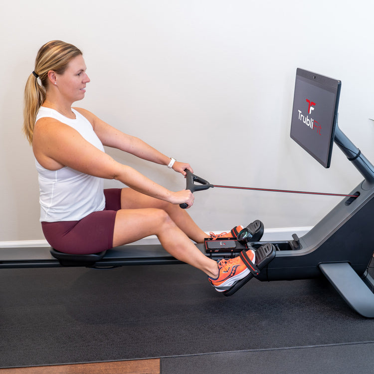 Girl on Peloton row with butt pad